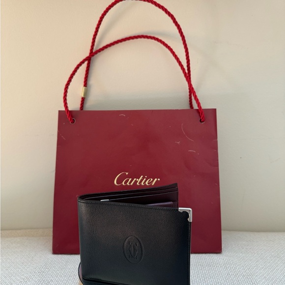 Cartier wallet. NWOT Brown exterior, burgundy interior. Shopping bag included. - Picture 3 of 10
